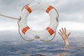 Man is drowning in ocean and is catching life buoy Royalty Free Stock Photo