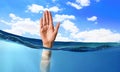 Hand of person drowning in water