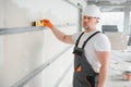 man drywall worker installing plasterboard sheet to wall Royalty Free Stock Photo