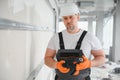man drywall worker installing plasterboard sheet to wall Royalty Free Stock Photo