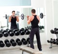 Man with dumbbell weight training equipment gym