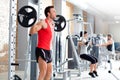 Man with dumbbell weight training equipment gym