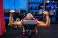 Man with dumbbells on weight bench Royalty Free Stock Photo