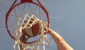 man dunking basketball ball through net ring with hands, sport Royalty Free Stock Photo