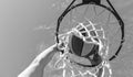 man dunking basketball ball through net ring with hands, sport Royalty Free Stock Photo