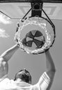 man dunking basketball ball through net ring with hands, success Royalty Free Stock Photo