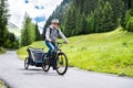 Man With E Bike MTB And Kid Trailer