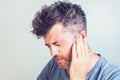 Man with earache is holding his aching ear body pain concept Royalty Free Stock Photo