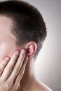 Man with a earache. Pain in the human body Royalty Free Stock Photo