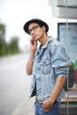 Man, earphones and listening to music, bus stop and commute or travel, adventure and journey in town. Male person Royalty Free Stock Photo