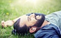 Man with earphones listening to music on grass Royalty Free Stock Photo
