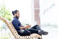 Man with earphones and smartphone on city bench Royalty Free Stock Photo