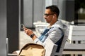 Man with earphones and smartphone on city street Royalty Free Stock Photo