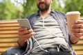 Man with earphones and smartphone drinking coffee Royalty Free Stock Photo