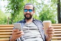 Man with earphones and smartphone drinking coffee Royalty Free Stock Photo