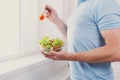 Unrecognizable man has healthy lunch, eating diet vegetable salad Royalty Free Stock Photo