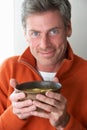 Man eating bowl of soup