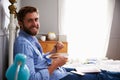 Man Eating Breakfast In Bed Whilst Using Mobile Phone Royalty Free Stock Photo