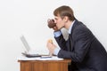 Man eating burger at desk Royalty Free Stock Photo