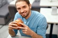 Man Eating Burger In Fast Food Restaurant. Royalty Free Stock Photo