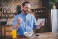 Man eating cereals and using digital tablet