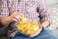 Man eating chips while watching TV Royalty Free Stock Photo