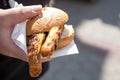 Man eating a couple of grilled Bavarian Bayreuth Bratwurst pork sausage with mustard in wheat bread bun of German food marked Royalty Free Stock Photo