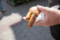 Man eating a couple of grilled Bavarian Bayreuth Bratwurst pork sausage with mustard in wheat bread bun of German food marked Royalty Free Stock Photo