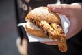 Man eating a couple of grilled Bavarian Bayreuth Bratwurst pork sausage with mustard in wheat bread bun of German food marked Royalty Free Stock Photo