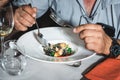 Man eating delicious salmon pasta in a restaurant. small portion Royalty Free Stock Photo