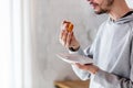 Man eating donut on breakfast at kitchen Royalty Free Stock Photo