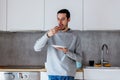 Man eating donut on breakfast at kitchen Royalty Free Stock Photo