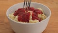 Man eating dumplings with ketchup a fork. Close up