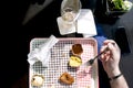 The man is eating fast food in a cafe. A table by the window. Empty dirty dish. Dinner. Cloth napkin. Royalty Free Stock Photo