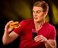 Man eating french fries and hamburger. Royalty Free Stock Photo