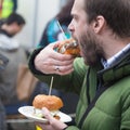 Man eating hamburgers on food festival in Ljubljana, Slovenia. Royalty Free Stock Photo