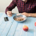 Man eating healthy breakfast in the kitchen at home Royalty Free Stock Photo