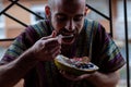 Man eating healthy breakfast in papaya bowl Royalty Free Stock Photo