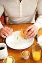 Man eating healthy breakfast at table Royalty Free Stock Photo