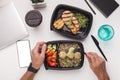 Man eating healthy food with grilled fish in office during lunch Royalty Free Stock Photo