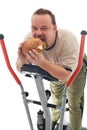 Man eating huge hamburger on a trainer device