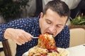 Man eating a large portion of pasta