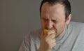 Man eating lemon and making silly faces