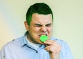 Man eating lemon. Wince from sour taste Royalty Free Stock Photo