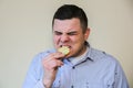 Man eating lemon. Wince from sour taste Royalty Free Stock Photo