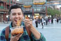 Man eating noodles outdoors in Asia