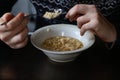 Man eating noodles soup. Men having lunch at home, tasting chicken soup in a bowl. Junk food. Spicy Korean instant noodle by using Royalty Free Stock Photo