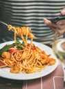 Man eating pasta and looking at smartphone Royalty Free Stock Photo