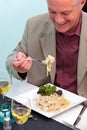 Man eating pasta in a restaurant Royalty Free Stock Photo