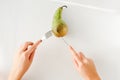 Man eating pear with fork and knife top view. healthy food concept. Healthy products, fruits on a white background. vegetarianism Royalty Free Stock Photo